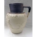 19TH CENTURY STONEWARE JUG WITH BROWN RIBBED RIM & CHERUB DECORATION - 29CM TALL