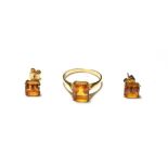 A citrine ring, stamped '9K', finger size Q1/2; and a pair of matching earrings, unmarked . The