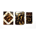 Three tortoiseshell card cases inlaid with mother of pearl. The body of the largest has been