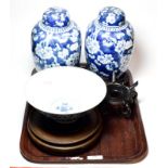 A pair of Chinese blue and white ginger jars and covers decorated in underglaze blue with prunus