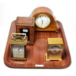 A brass carriage timepiece with fitted travelling case, inlaid mantel timepiece and a brass desk
