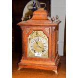 An oak quarter striking mantel clock