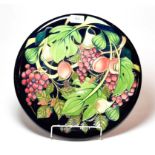 A Moorcroft Queen's Choice pattern charger, designed by Emma Bossons, 35.5cm diameter.. Second