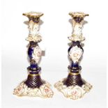 A pair of 19th century English porcelain cobalt blue floral and gilt decorated candlesticks,