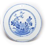 A 19th century Chinese export blue and white charger (a.f.). Cracked right through and repaired.,