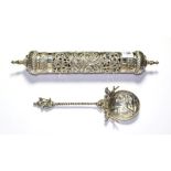 A white metal scroll holder, possibly Indian, cylindrical, with pierced sides and finial ends,