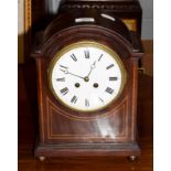 An Edwardian mahogany inlaid striking mantel clock . Clock comes with a key, movement is going order