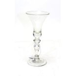 A baluster wine glass, circa 1740, the bell shaped bowl on an annular knop and baluster stem with