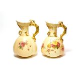 A pair of Royal Worcester blush ivory ewers, 16.25cm. . Some patches of wear to the gilding. No
