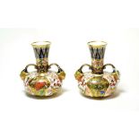 A pair of Royal Crown Derby Imari pattern twin handled vases (2). No damage or repair. Some light