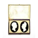 Two oval jet plaques applied with cameos in profile, cased . Each plaque measures 3.5cm by 4.5cm