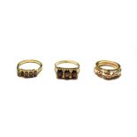 Three 9 carat gold rings including two garnet examples, various designs and finger sizes (one a.f.).
