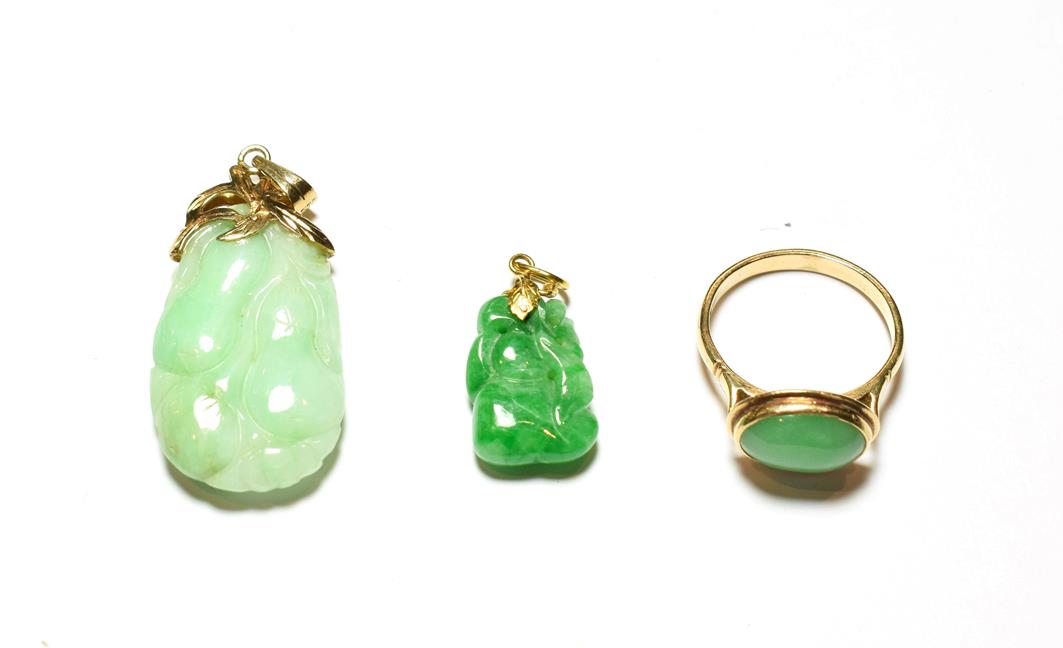 A jade ring, stamped '14K', finger size Q1/2; and two jade type pendants . Ring - 4.0 grams.