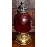 A cranberry glass brass oil lamp