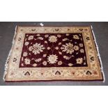 Afghan Agra rug, the deep aubergine field of large palmature vines enclosed by meandering vine