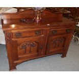 An Arts & Crafts oak sideboard, carved with stylised flower and brass handles, 152cm by 54cm by 95cm