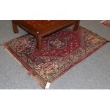 Kashgai rug, the raspberry field with stepped medallions framed by narrow borders, 160cm by 111cm