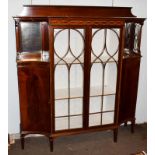 An Edwardian inlaid mahogany display cabinet, the two glazed doors flanked by mirrored recesses