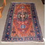 Zabul Baluch rug, the chestnut brown field with central panel frame enclosed by spandrel and