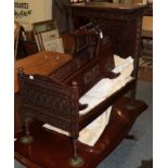 Decorative carved oak dolls half tester bed with bedding and drapes, 88cm by 52cm by 86cm; and an