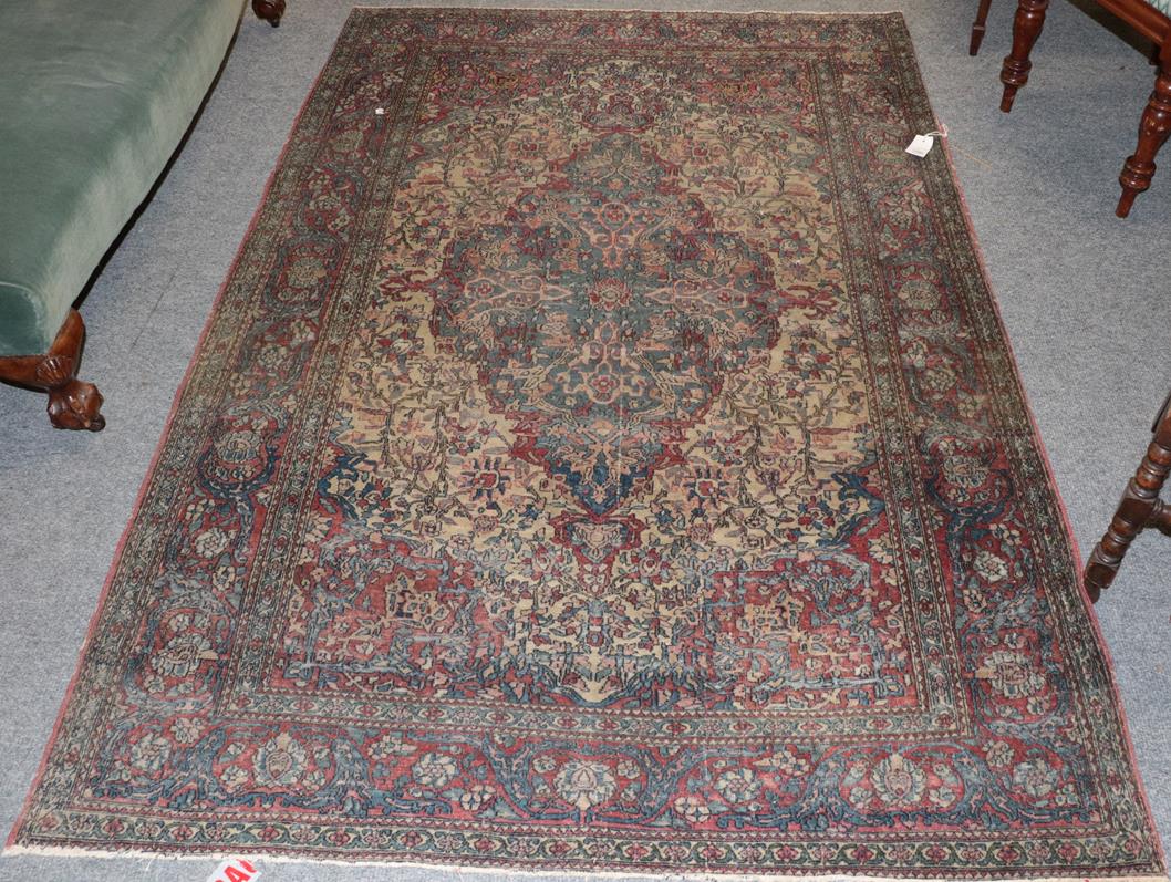 Isfahan rug, the central medallion surrounded by scrolling flowering vines, enclosed in a red