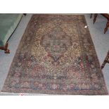 Isfahan rug, the central medallion surrounded by scrolling flowering vines, enclosed in a red