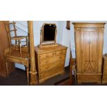 A five piece bedroom suite comprising a chest of drawers, wardrobe, dressing table mirror, wash