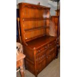 A 20th century oak dresser and rack, bearing label J H Hesketh & Son. Ltd. Burnley, 107cm by 47cm by