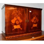 A 19th century Dutch mahogany and marquetry inlaid double door cabinet, inlaid overall with