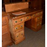 A leather inset oak pedestal desk, with burr walnut drawer fronts, bearing paper label John Manuel &