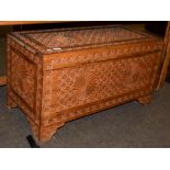 A carved camphor wood chest, 90cm by 42cm by 49cm