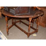 An early 19th century oak gateleg dining table, 148cm by 123cm by 73cm high