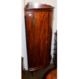 A mahogany free standing bow fronted corner cabinet, 70cm by 48cm by 138cm