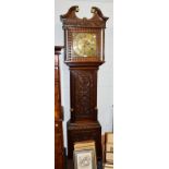 A carved oak thirty hour longcase clock, the square brass dial signed Ewbank, Elland . Case faded in