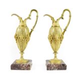 A Pair of French Gilt Bronze Ewers, mid 19th century, of baluster form with fluted scroll handles,