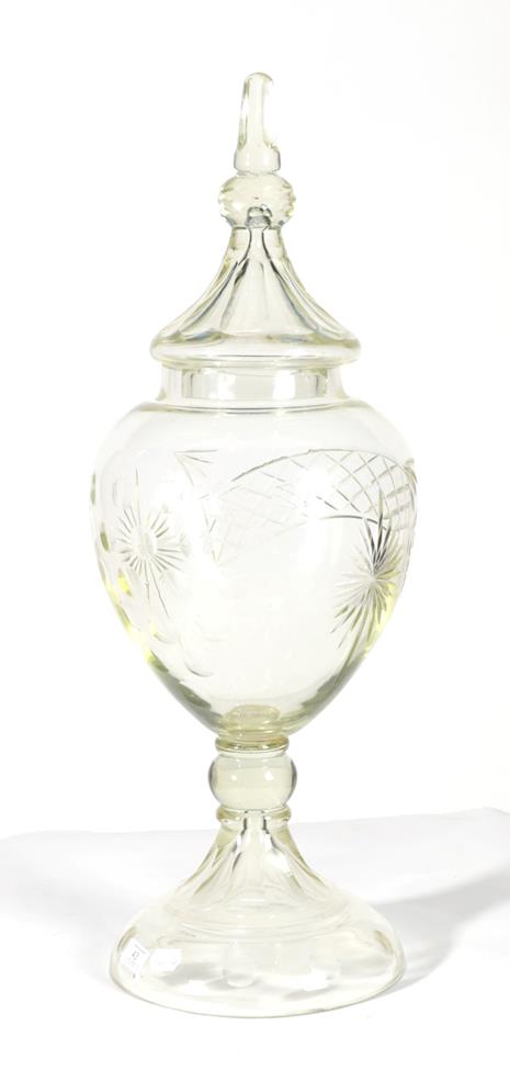 An Apothecary's Glass Display Jar and Cover, late 19th/early 20th century, of ovoid form, cut with a