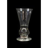 A Thistle Shaped Dram Glass, circa 1760, the conical bowl on a basal ball knop with air tear and