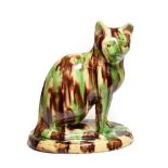 A Slipware Model of a Seated Cat, possibly Canny Hill Pottery, Bishop Auckland, circa 1860, on an