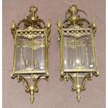 A Pair of Brass Hanging Lanterns, of square form, with scroll superstructure, fluted finials,