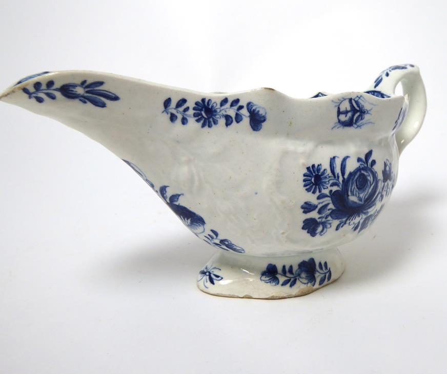 A Bow Porcelain Sauceboat, circa 1770, printed in underglaze blue with stylised foliage, 20cm - Image 18 of 19