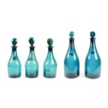 A Matched Set of Three Green Glass Spirit Decanters and Stoppers, early 19th century, of mallet