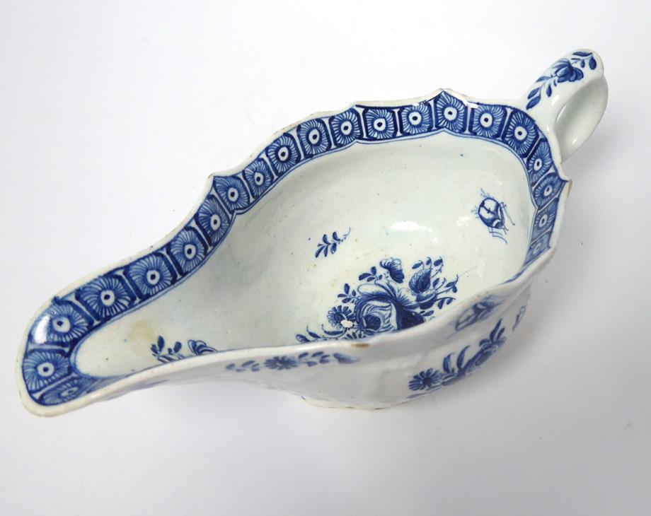 A Bow Porcelain Sauceboat, circa 1770, printed in underglaze blue with stylised foliage, 20cm - Image 17 of 19