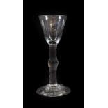 A Cordial Glass, circa 1760, the rounded funnel bowl on a knopped plain stem and folded foot, 14.5cm