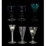 A Pair of Green Glass Wine Glasses, early 19th century, the ovoid bowls with everted rims on blade