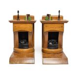 A Pair of Oak and Painted Wood Bookends, 20th century, each modelled as a fireplace, a candlestick