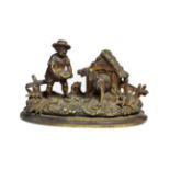 A Bronze Inkwell, late 19th century, cast as a boy feeding a dog in a kennel, 18cm wide. Good