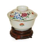 A Chinese Porcelain Rice Bowl and Cover, Qianlong, painted in famille rose enamels with foliage