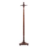 A Mahogany Hat Stand, circa 1840, with spindle support and four turned arms in the form of pegs,
