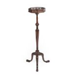A Carved Mahogany Torchère, circa 1900, labelled Denby & Spinks, House Furnishers, Leeds, with a