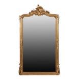 ~ A French Gilt and Gesso Bevelled Glass Mirror, circa 1870, the arched rectangular plate within a